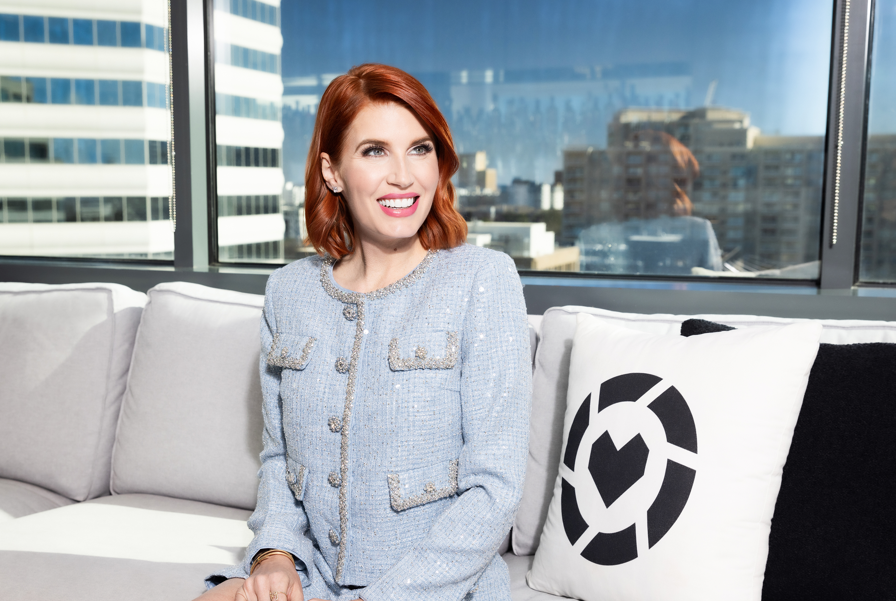 An LTK Creator sitting in a white room and shopping on her phone