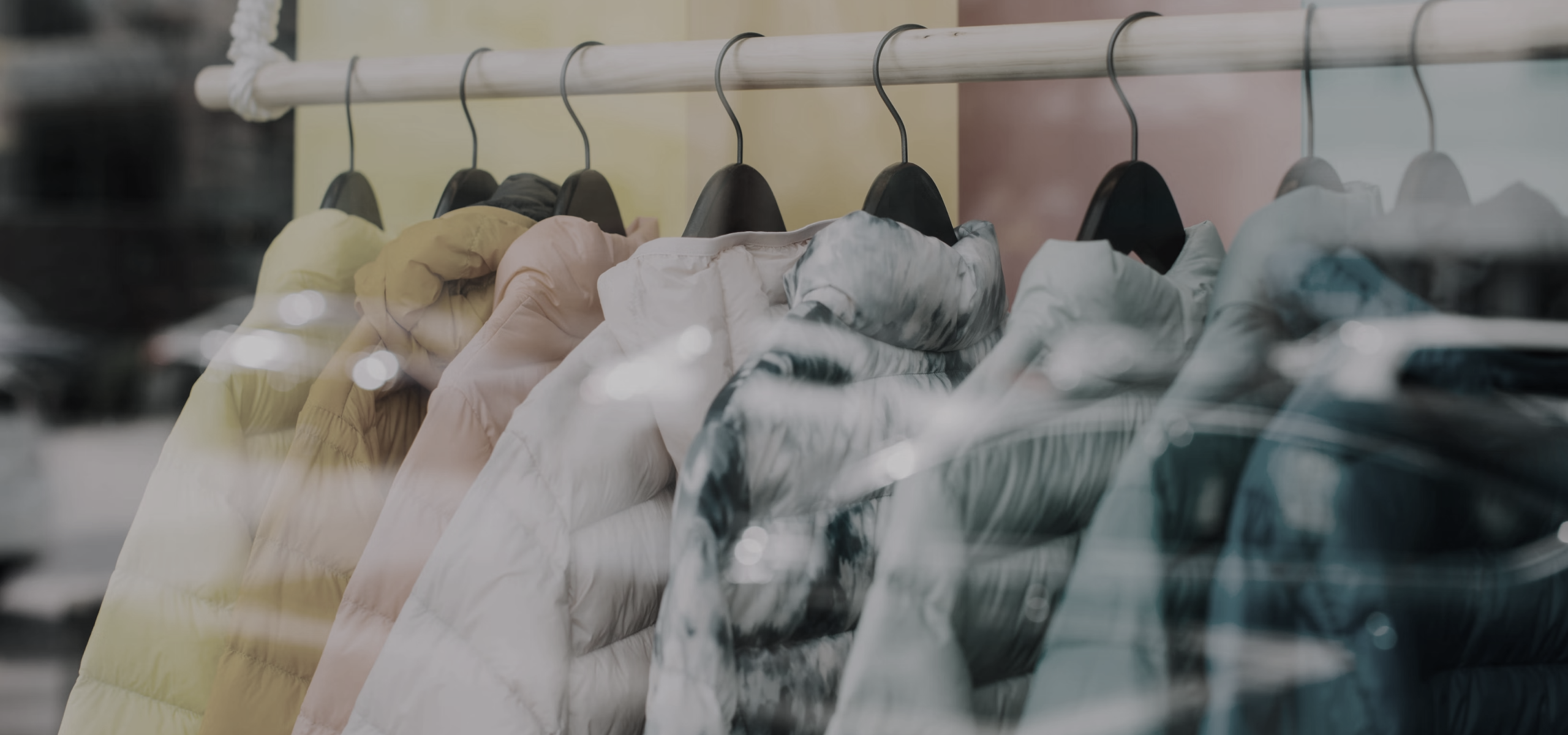 Coats hanging on a coat rack is the featured image on A Guide to Creator Marketing for Retail Media