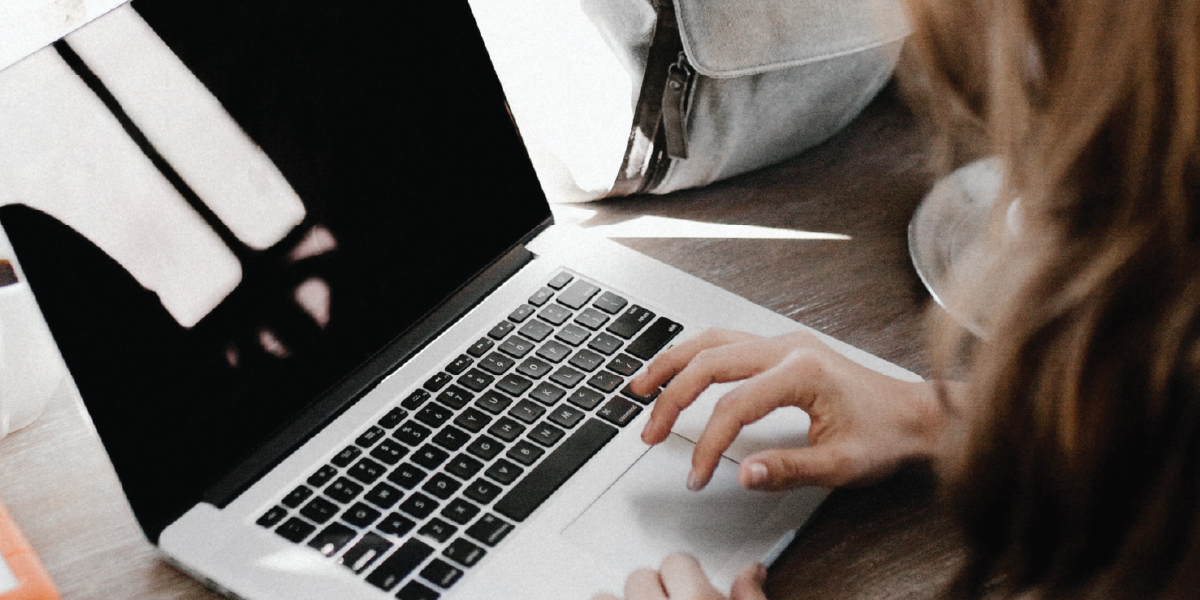 Woman working on a creator marketing campaign on laptop at desk 